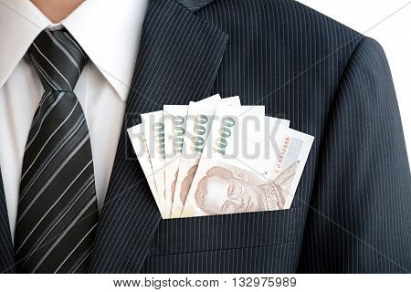 Money in businessman suit pocket - Thai baht (THB) currency