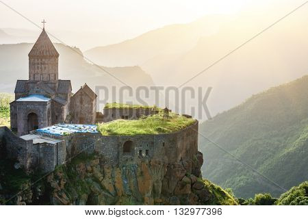 Ancient monastery in setting sun. Tatev. Armenia