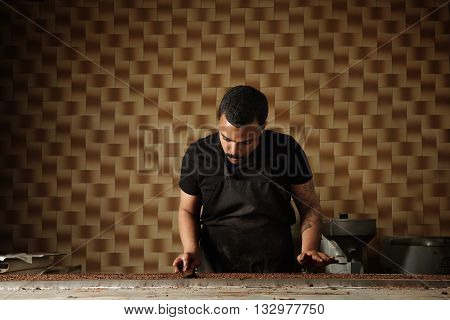 Black Man Cooks Chocolate Cakes In His Professional Artisan Confectionery Checking Condition Of Melt