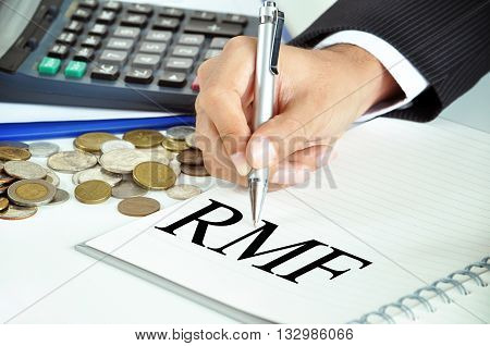 Businessman Hand With Pen Pointing To Rmf (retirement Mutual Fund) Sign On The Paper