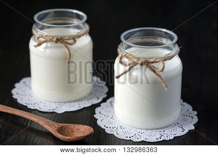 natural yogurt in a jar on the dark background