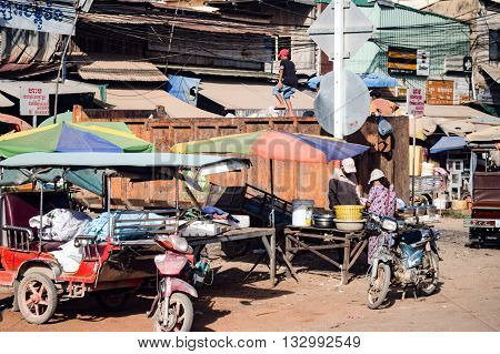 Cambodia - November 22, 2014: Local Cambodian street scene showing boys climbing and playing on a large rubbish bin