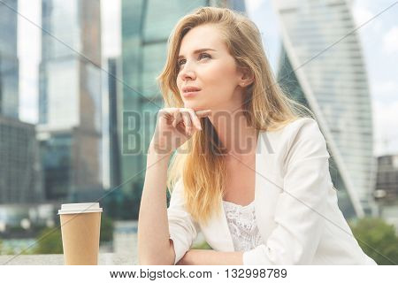 Portrait of young beautiful business woman with cup of coffee