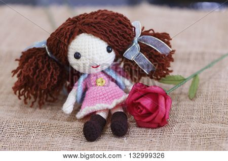 Baby doll made with knitting wool sit on sackcloth