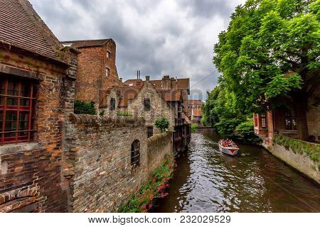 Bruges, Belgium - June 10, 2014: Scenic View Of Water Canal And Tourist Boat In Bruges, Belgium. It 