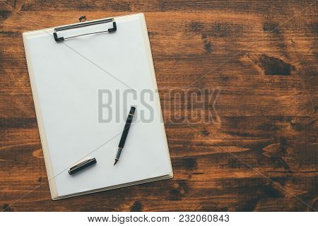 Overhead View Of Blank Clipboard Note Pad Paper With Pen On Office Table As Mock Up Copy Space For C