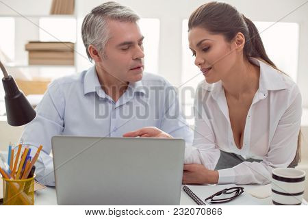 Inappropriate Interest. Pleasant Attractive Young Woman Sitting Together With Her Male Colleague And