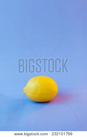 Fresh Lemon On A Violet Blurred Background.