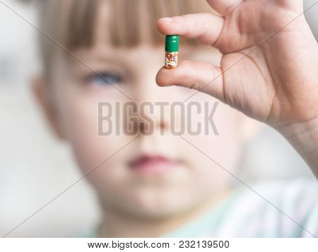 Young Girl Showing Off Her Chewable Vitamin C Tablet Selected Focus. Toned.