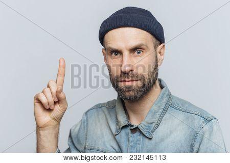 Indoor Shot Of Handsome Man With Serious Look, Has Pleasant Appearance, Thick Beard With Mustache, W