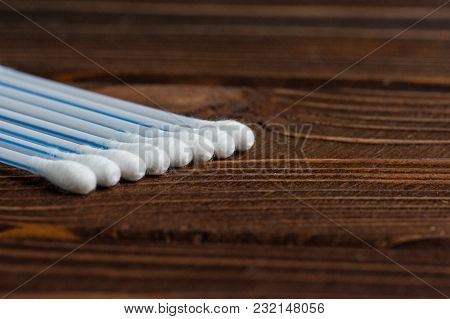 Ear Wand Of White Cotton Buds Or Cotton Swab On Wooden Background.