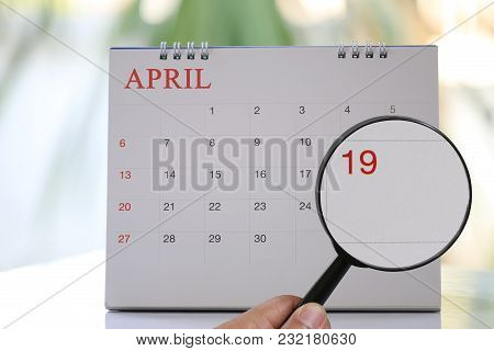 Magnifying Glass In Hand On Calendar You Can Look Nineteenth Day Of Month,focus Number Nineteen In A