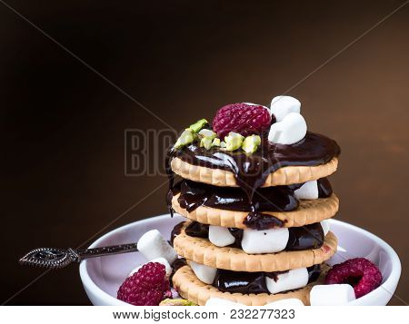 A Sweet Dessert Of Chocolate Biscuit, Raspberry Marshmallow And A Cup Of Coffee On Dark Background.