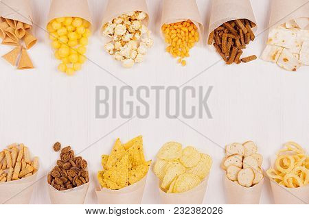 Snacks Collection In Craft Paper Cornets On White Wooden Board, Top View, Border.