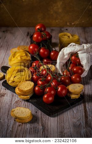 Red Cherry Tomatoes On Several Twigs With Pasta