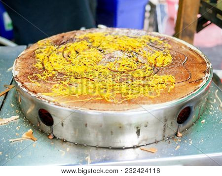 Crepe Filling With Chocolate Sauce And Fios De Ovos Being Cooked On Crepe Maker