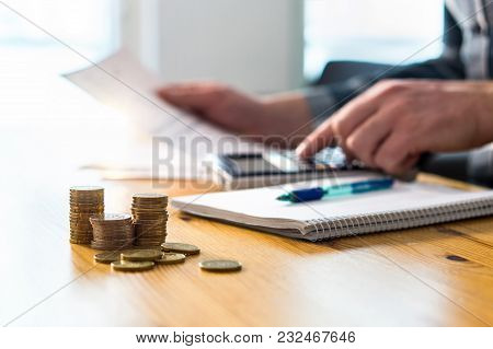 Man Using Calculator And Reading Financial Document Paper. Entrepreneur, Bookkeeper Or Accountant Wo