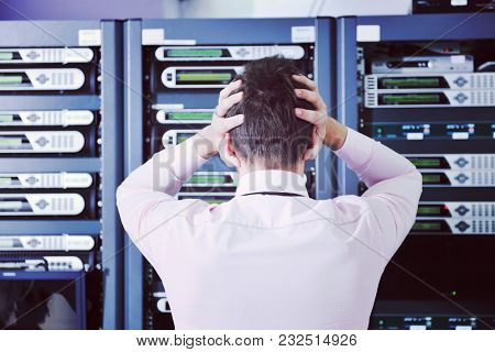 it business man in network server room have problems and looking for  disaster situation  solution