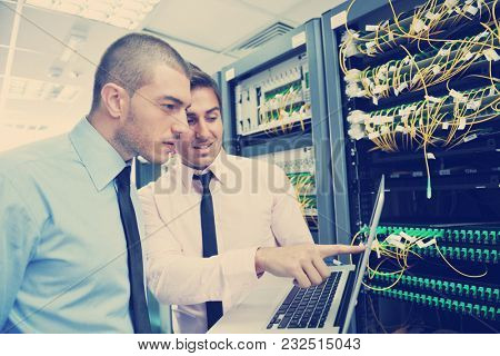 group of young business people it engineer in network server room solving problems and give help and support