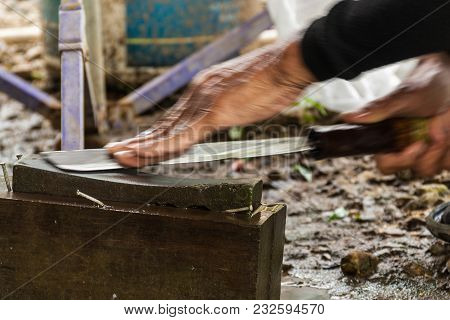 Knife Whetting, Thai Villager Is Whetting The Knife Before Cooking The Meal.