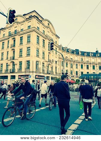 Munich Germany -september 8, 2017; People Crossing Street On Foot And Riding Bicycles  To And From K