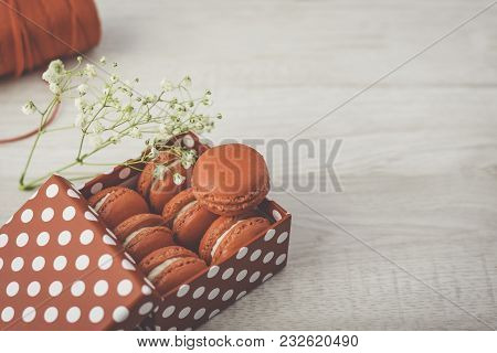 Stylish Red Dots Box With Tasty Macarons On Wooden Background. Minimalist Concept Of Style And Frenc
