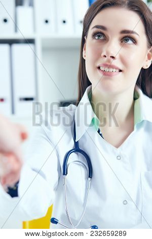 Beautiful Smiling Female Medicine Doctor Shaking Hands With Patient. Partnership, Trust And Medical 