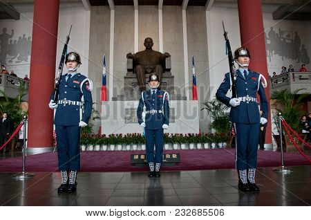 Taipei, Taiwan - February 3, 2015: Taiwanese Soldier Salutes To The Statue Of Dr. Sun Yat Sen In A M