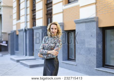 Young Female Teacher Standing Near University Building Outdoors. Concept Of Education And Beauty.