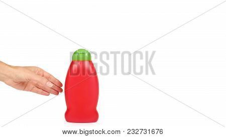 Red Plastic Bottle For Shampoo In Hand Isolated On White Background. Hydiene And Cleaning Idea. Copy