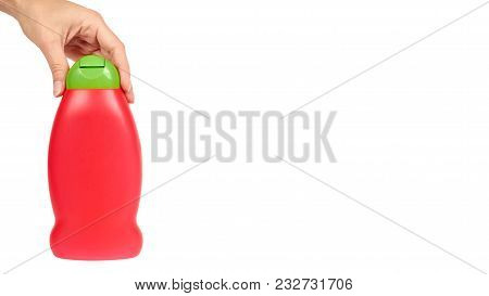 Red Plastic Bottle For Shampoo In Hand Isolated On White Background. Hydiene And Cleaning Idea. Copy