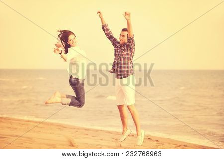 happy young couple have fun and romantic moments on beach at summer season and representing happynes and travel concept