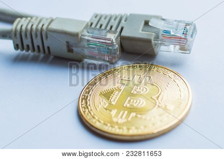 Bitcoin Gold Coin And Network Wire Connectors Patch Cord Cable. Concept Of Digital Money Transfer.