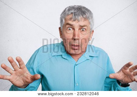 Scared Matured Wrinkled Male Expresses Negative Emotions, Gestures And Looks With Unexpected Express