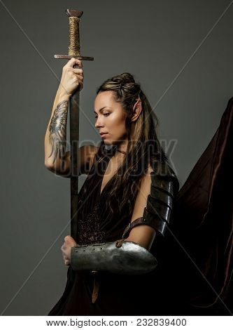 Beautiful Elf Woman With Bow In Her Hand. Isolated On Gray.