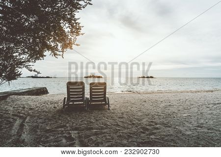 Two Empty Recliners On The Coastline With The Pier On The Left And Ocean Horizon In Front; Daybeds O