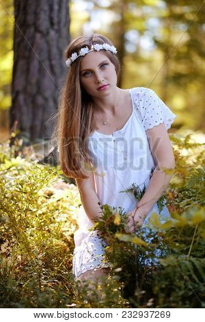 Freckled Woman With Circlet Of Flower On Her Head Portrait In Autumn Forest In A Day Light.