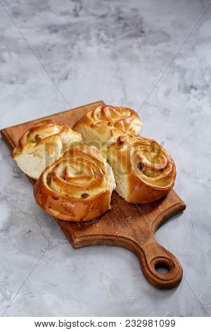 Homemade Rose Buns With Raisins On Wooden Cutting Board Over White Textured Background, Close-up, Sh