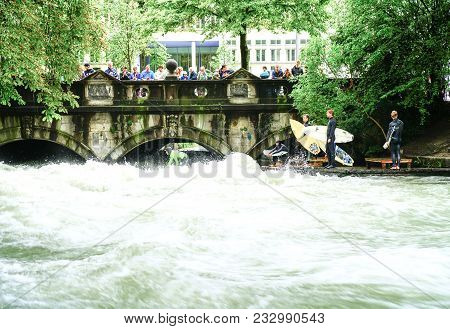 Munich Germany _ September 11 2017; River Surfers Challenge Raging Rapids On Eisbach River In Middle