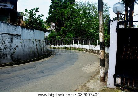 Shillong, Meghalaya, India, 16 June, 2019: The Curved Road Along A High Wall In The Hills Of Shillon