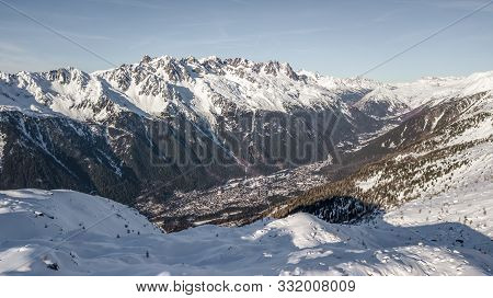 Aerial Drone View Of Chamonix City At The Foot Of Snowy Mountain Brevent