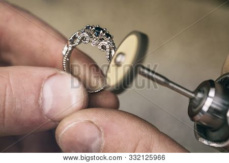 Jeweler Polishes A Gold Ring In The Workshop. Close-up Workflow