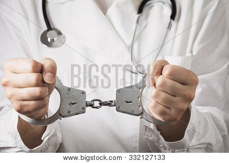 Handcuffed Doctor, Close-up. Medical Malpractice And Error Concept