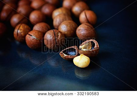 Unpeeled Macadamia Nuts Laying On Blue Cloth