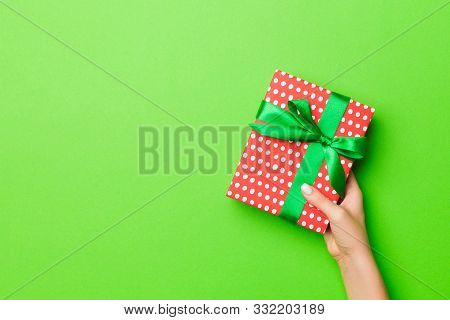 Top View Of Female Hands Holding Christmas Or Other Holiday Handmade Present Box Package In The Palm