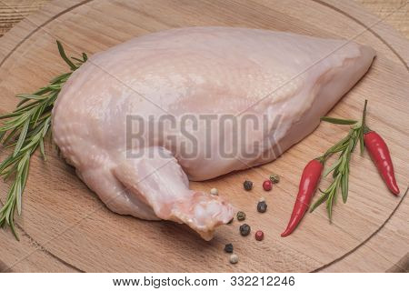 Raw Chicken Meat On Wooden Board. Fresh Chicken Meat. Fresh Chicken Fillet With A Wing On A Wooden C
