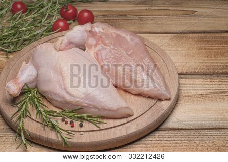 Raw Chicken Meat On Wooden Board. Fresh Chicken Meat. Fresh Chicken Fillet With A Wing On A Wooden C