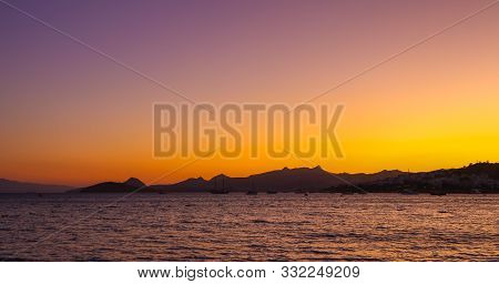 Beautiful Bright Colorful Sunset On The Mediterranean Sea With Islands, Mountains And Boats