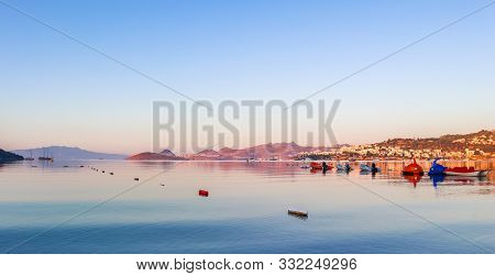 Beautiful Sunrise On Mediterranean Coast With Islands And Mountains, Boats And Catamarans