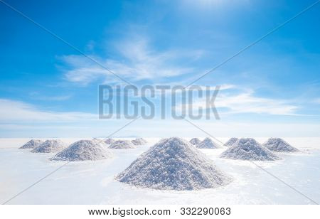 Salt hills of Salar de Uyuni drying on sun at hot clear day, Bolivia
